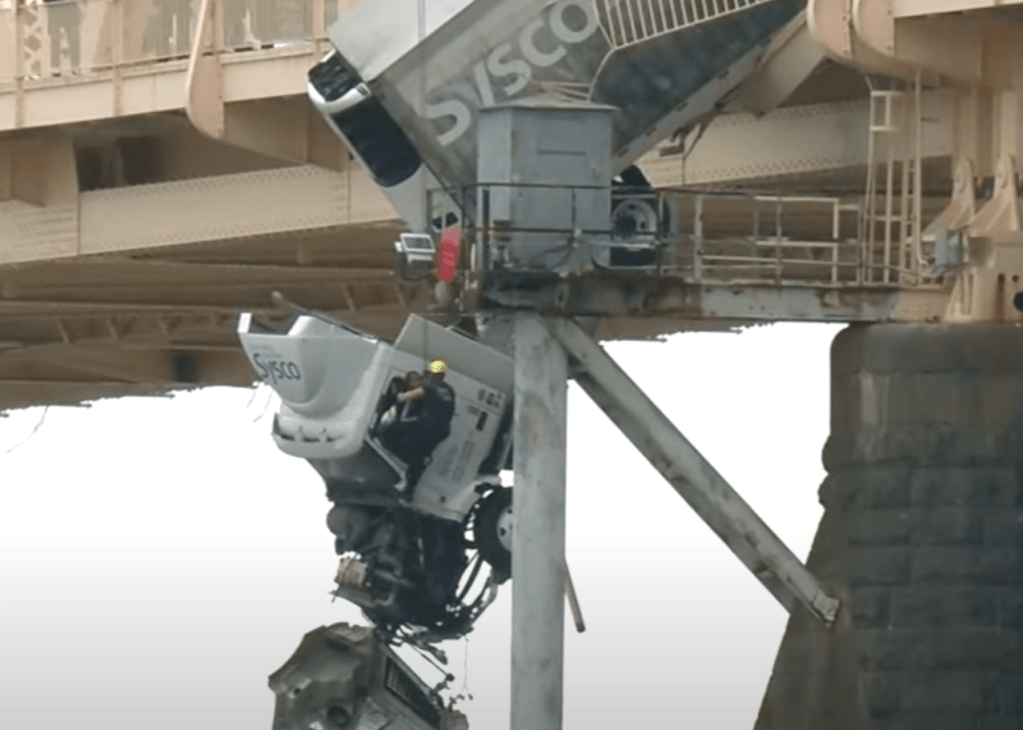 Semi truck dangles off the Clark Memorial Bridge in Kentucky. 